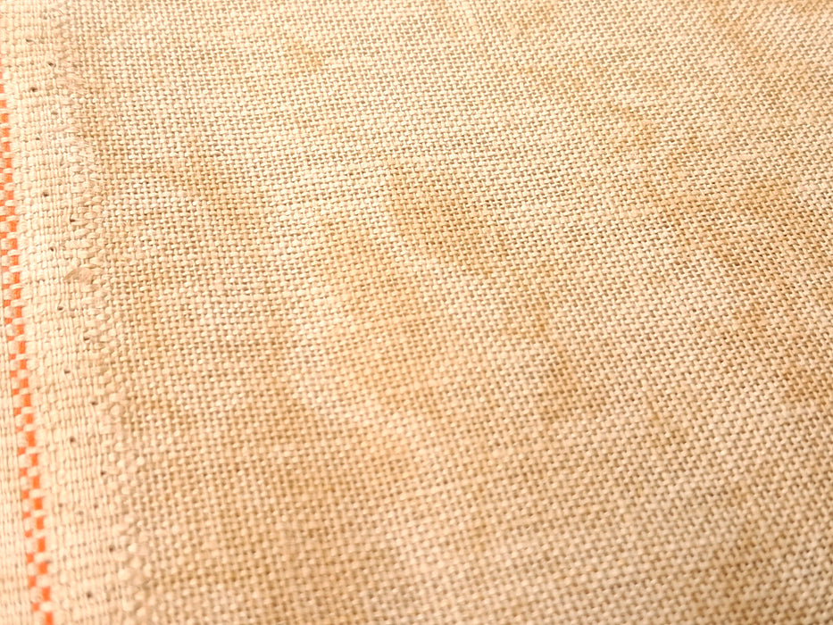 Close-up of beige fabric with a subtle pattern