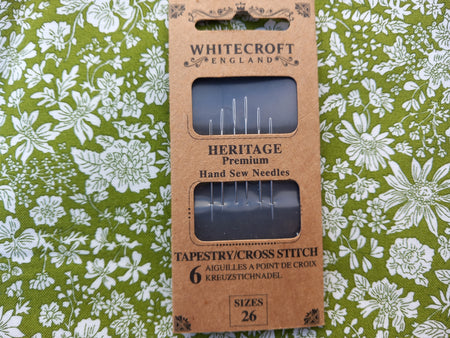 Pack of Whitecroft England hand sew needles on a floral green background
