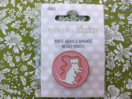 Pink Bohin needle minder on floral background